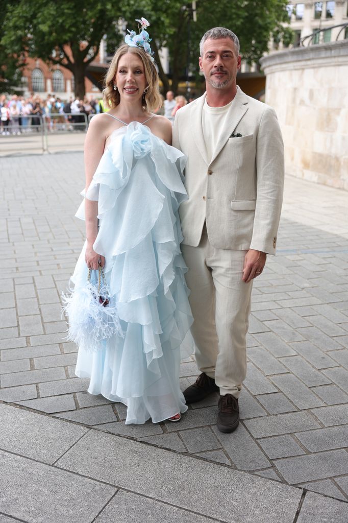 Katherine Ryan in pale blue dress beside partner Bobby