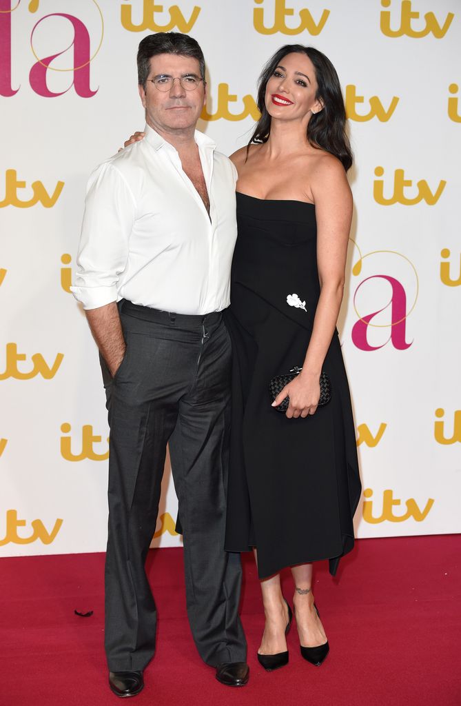 Simon Cowell in white shirt and Lauren Silverman in black dress at the ITV Gala at London Palladium