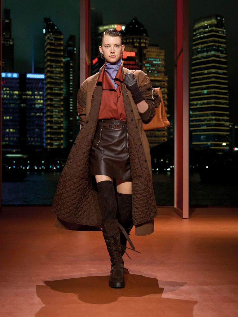 A model walks down the runway in a top toe toe chocolate brown ensemble 