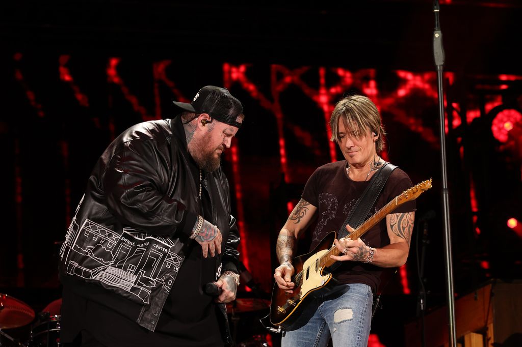 Jelly Roll and Keith Urban perform onstage during the 2024 CMA Music festival at Nissan Stadium on June 08, 2024 