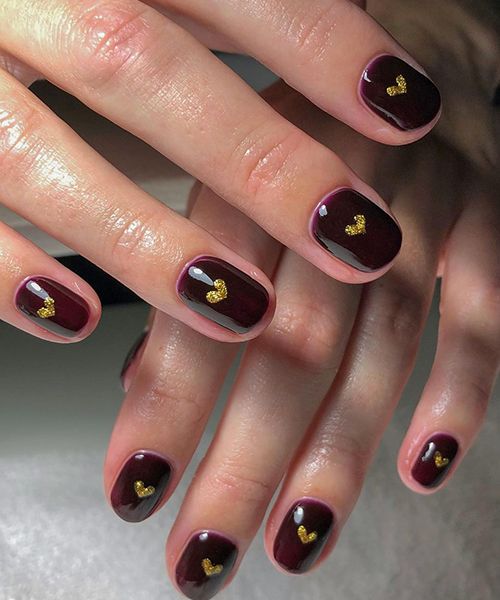 dark red nails with gold hearts by clwnailartist