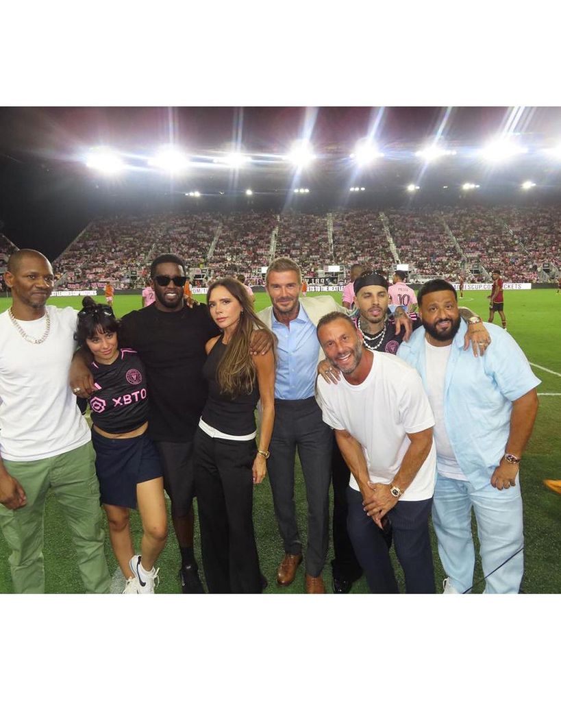 Victoria and David Beckham posing on pitch after Inter Miami CF soccer game