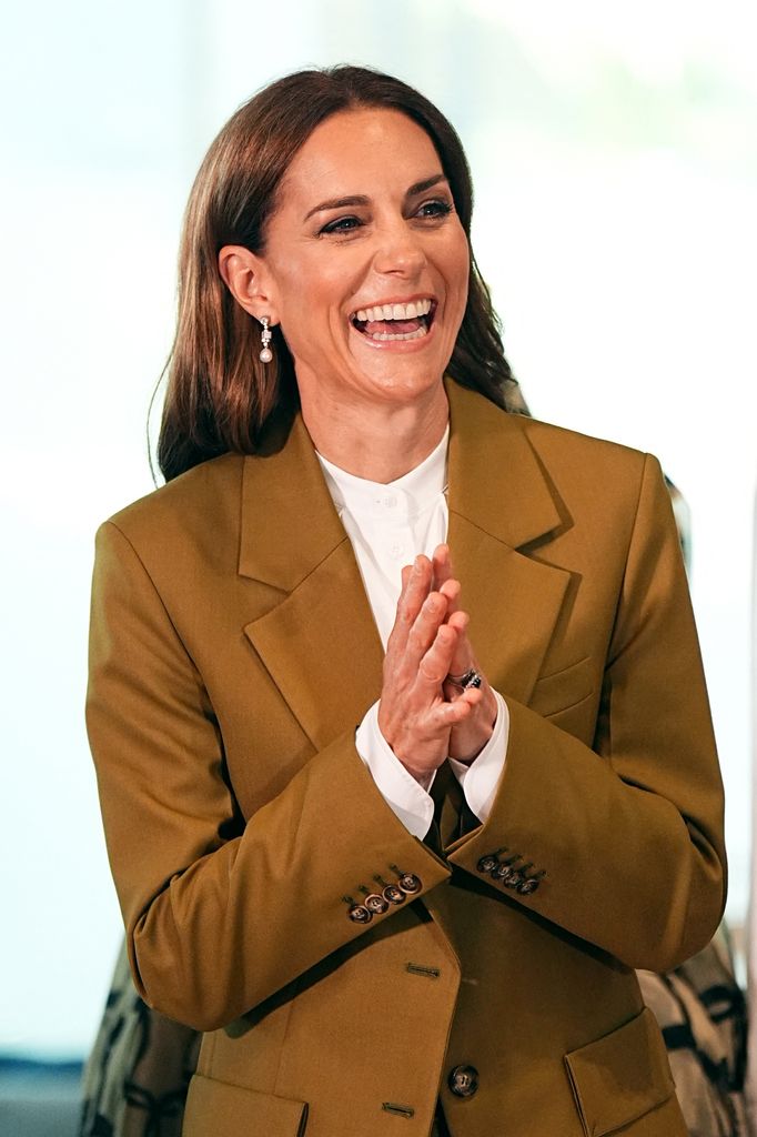 Kate Middleton smiling in olive suit