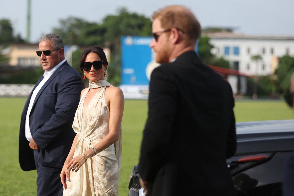 Britain's Meghan (C), Duchess of Sussex, and Britain's Prince Harry (L), Duke of Sussex, arrive at a charity polo game at the Ikoyi Polo Club in Lagos on May 12, 2024 as they visit Nigeria as par