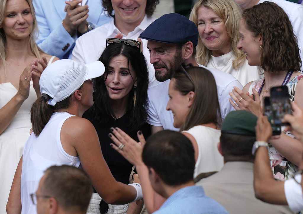 Courteney Cox and Johnny McDaid celebrate with Iga Swiatek following the Ladies' Singles Final on day thirteen of the 2025 Wimbledon Championships