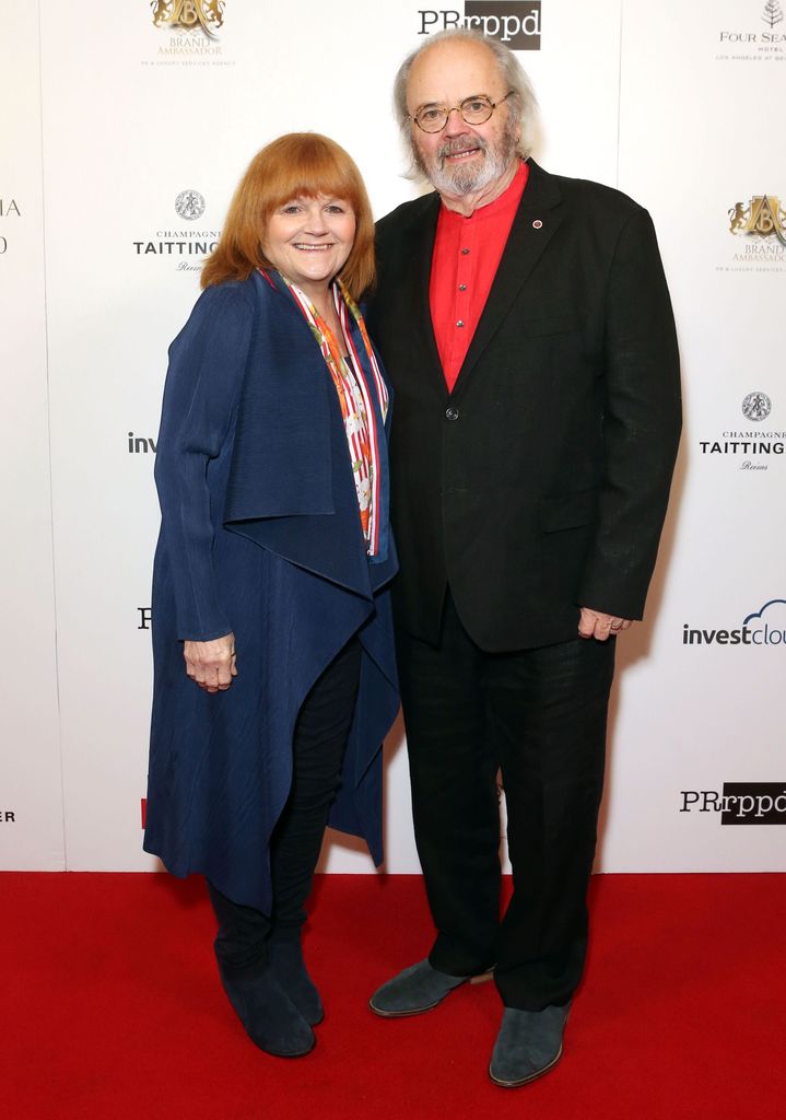 woman and man posing on red carpet