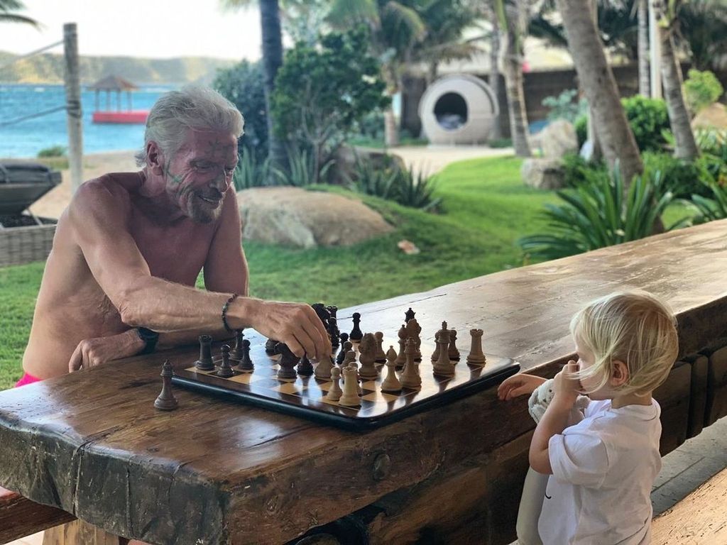 Sir Richard Branson plays chess with his grandson Artie