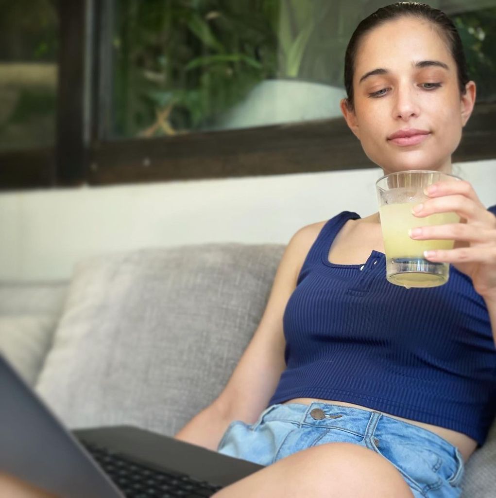 Molly Hurwitz sits on sofa with a drink