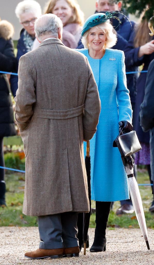 Camilla in a blue coat with Charles