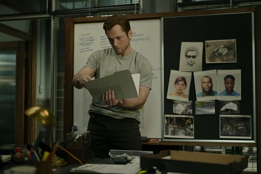 man looking at files in office