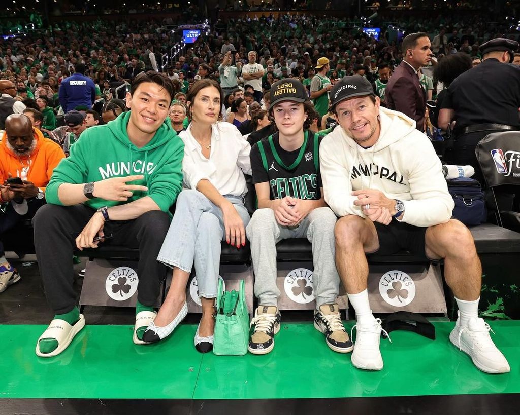 Brendan sits between Rhea and Mark courtside