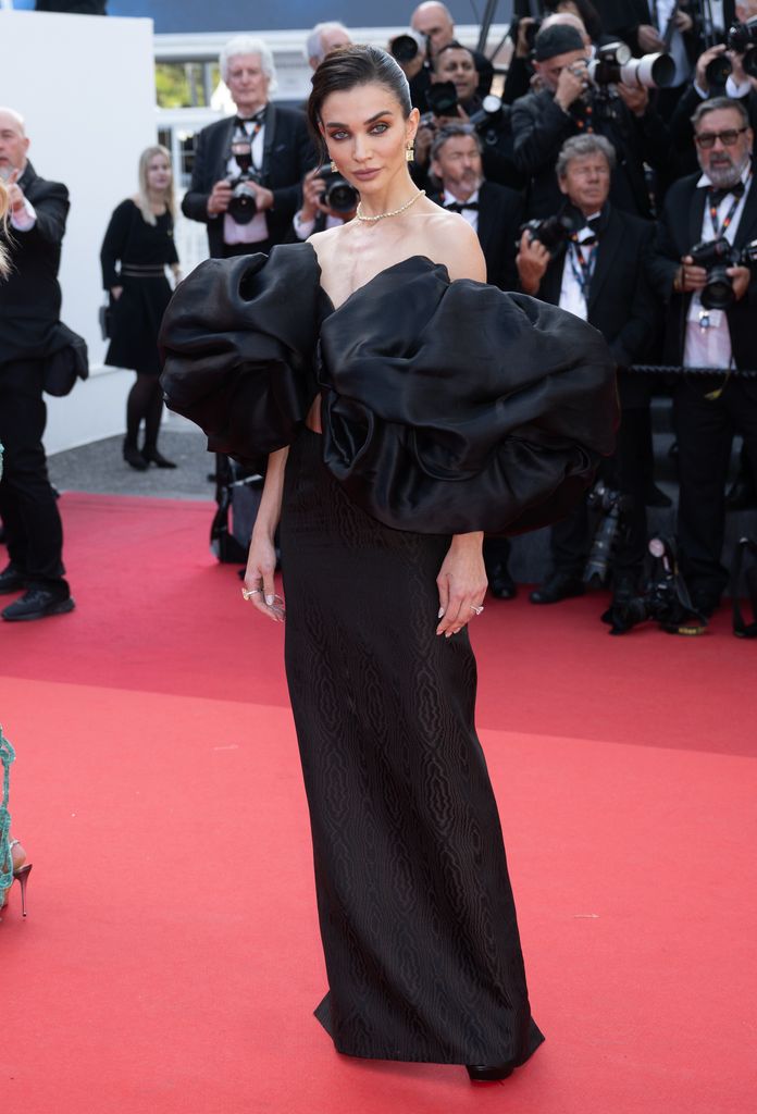 Amy Jackson attends the "Horizon: An American Saga" Red Carpet at the 77th annual Cannes Film Festival at Palais des Festivals on May 19, 2024 in Cannes, France in a black gown