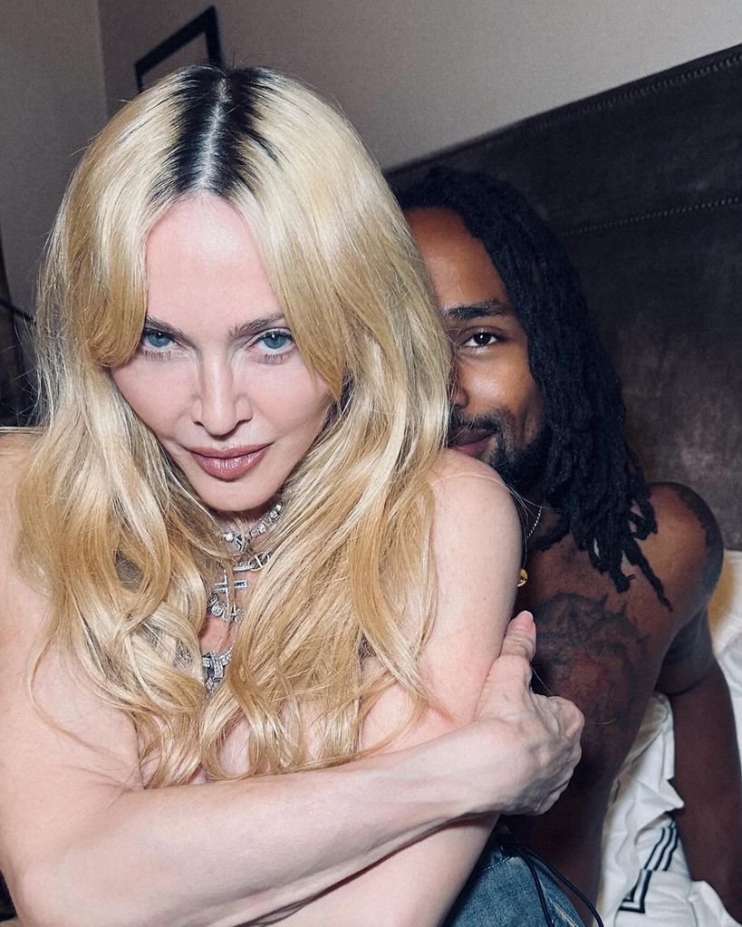 madonna posing topless with mystery man in bed