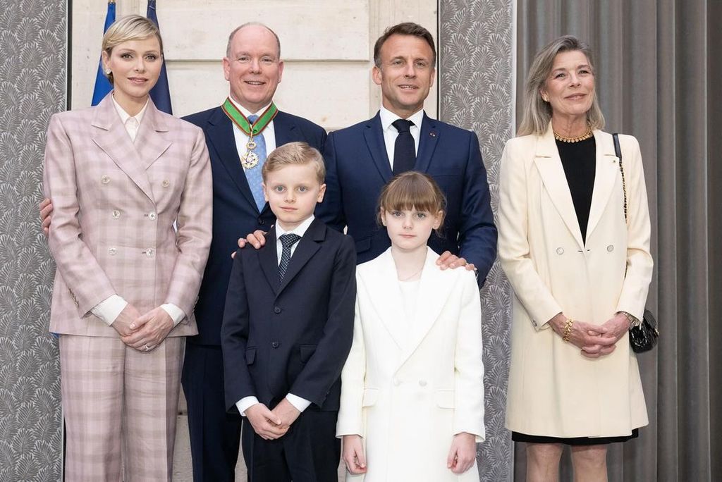 Princess Charlene wears a pink suit next to her husband Prince Albert, their children Jacques and Gabriella, and President Emmanuel Macron