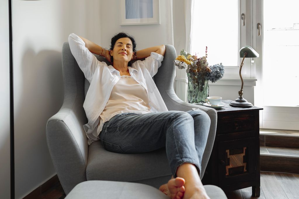 woman lying back in an armchair