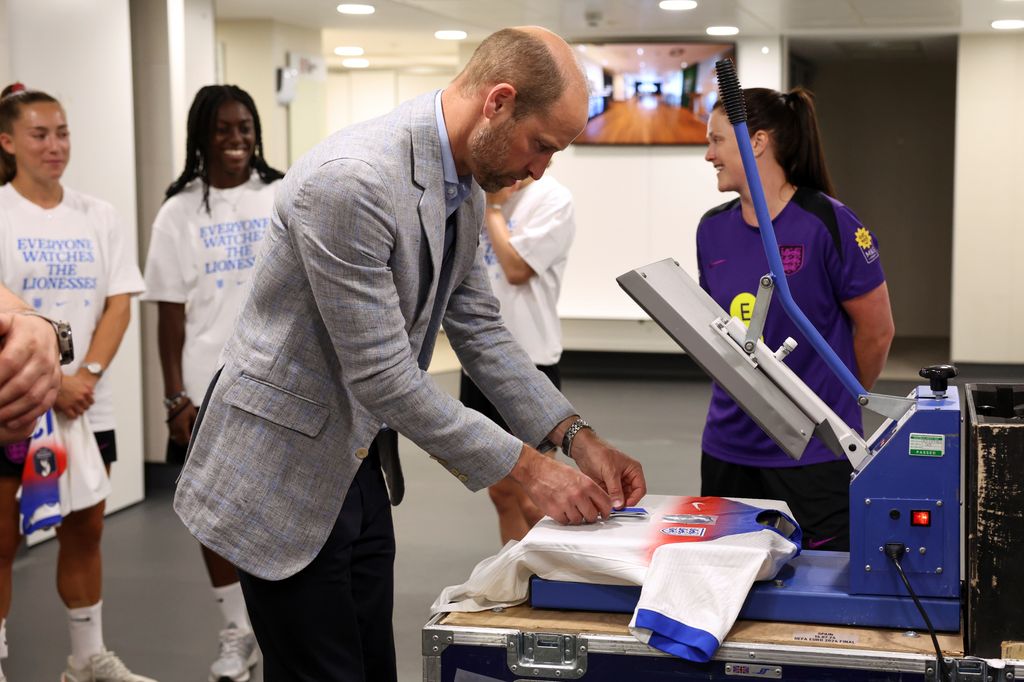 Prince William, Prince of Wales, Patron of The Football Association, puts a number on a shirt for printing