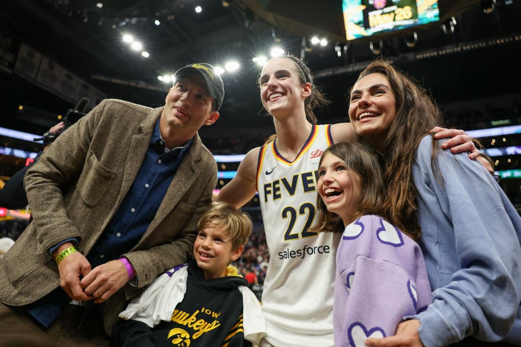 Caitlin Clark of the Indiana Fever poses for pictures with Ashton Kutcher, Mila Kunis and their kids after defeating the Los Angeles Sparks 78-73 to win a WNBA basketball game at Crypto.com Arena in Los Angeles on Friday, May 24, 2024