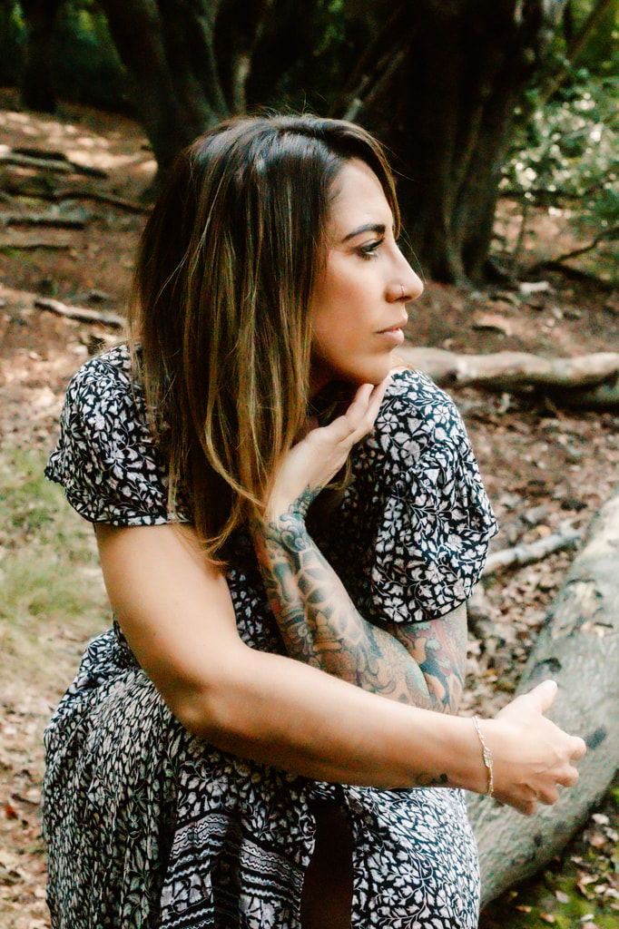 Kirsty sits in contemplation in the woods
