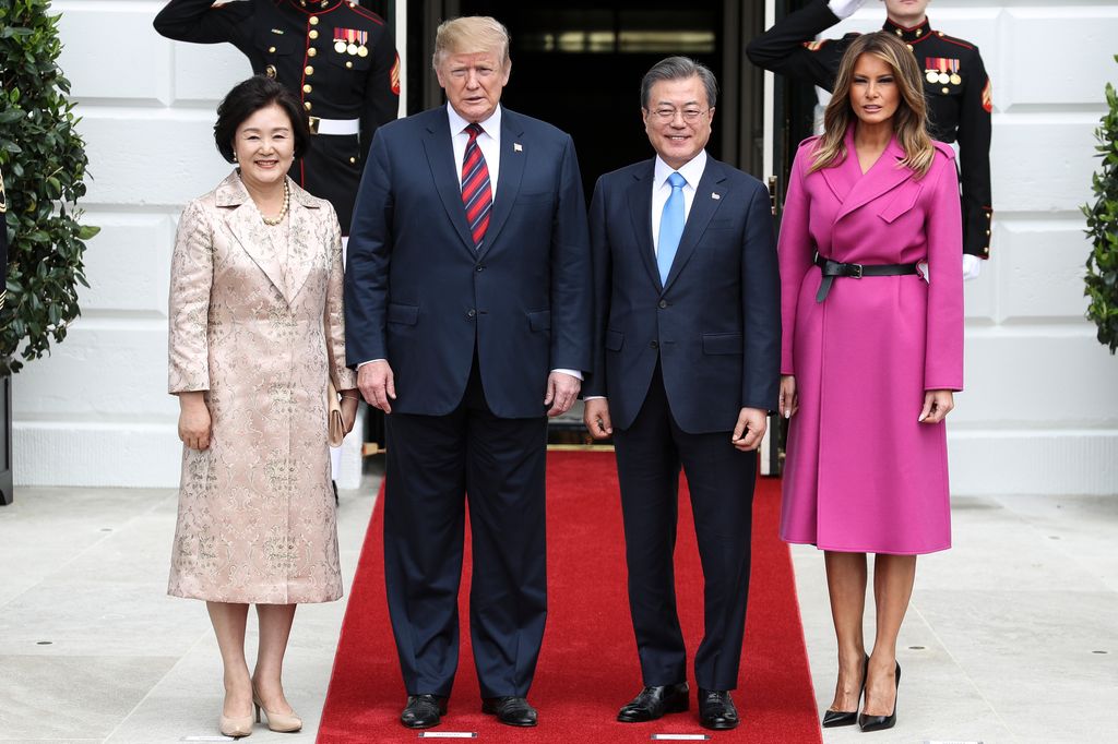 Melania Trump in a Louis Vuitton pink wrap coat alongside Donald Trump and South Korean President Moon Jae-in and his wife Kim Jung-Soon at the White House