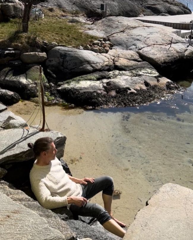Morton Harket sitting by the beach