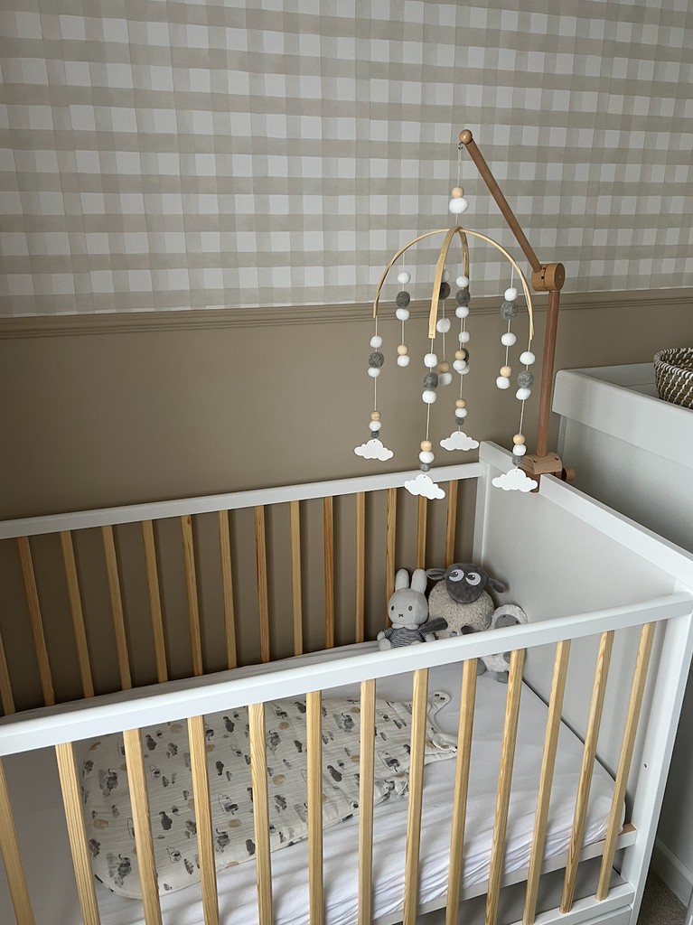 cot with mobile soft toys and sleeping bag