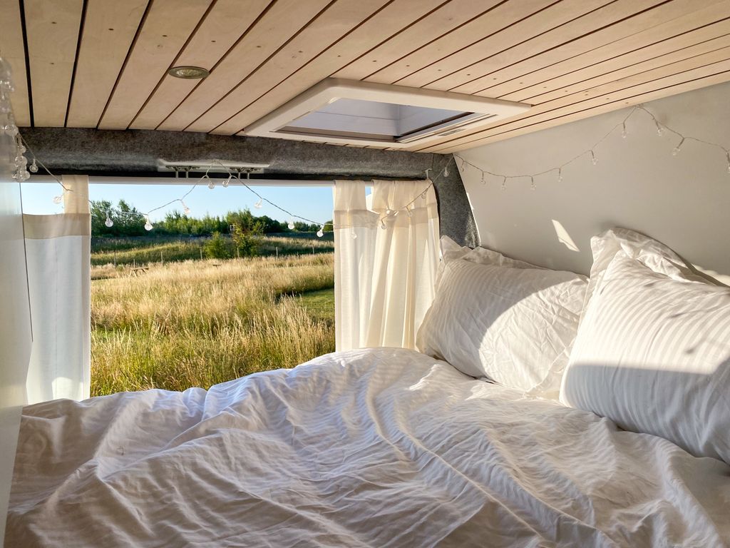 a bed inside a camper van