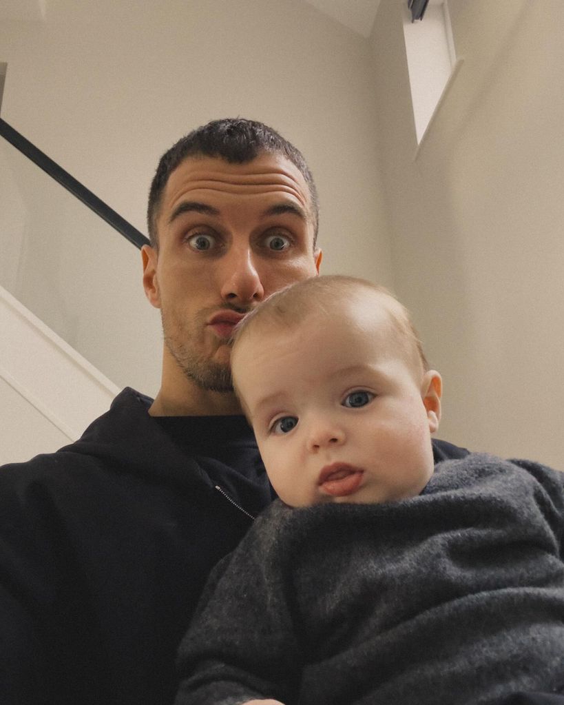 father with baby taking selfie 