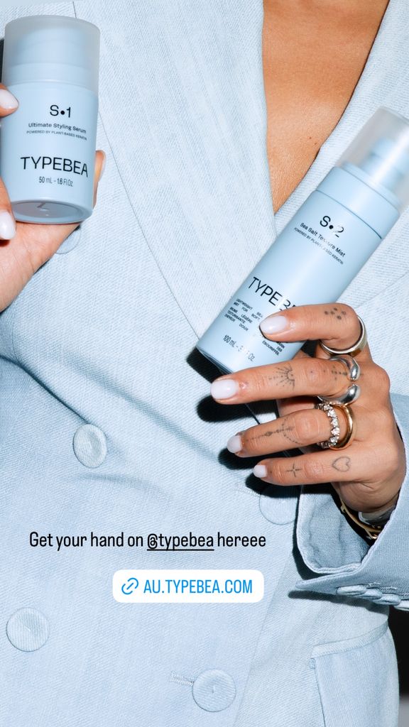 A close-up of Rita’s hands holding Typebea styling products, showcasing delicate jewelry, chic tattoos, and perfectly manicured nails.