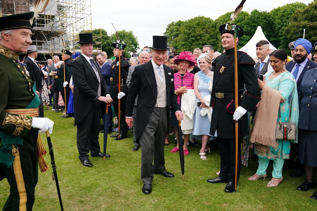 King Charles wearing top hat at garden party
