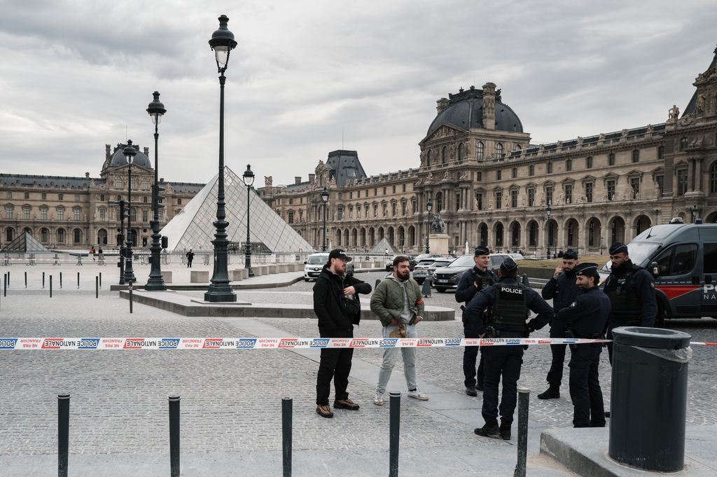 French police officers stand in front of the Louvre Museum after a robbery in Paris, France, on October 19, 2025. Robbers break into the Louvre and flee with jewelry on the morning of October 19, 2025, a source close to the case says, adding that its value is still being evaluated. A police source says an unknown number of thieves arrive on a scooter armed with small chainsaws and use a goods lift to reach the room they are targeting