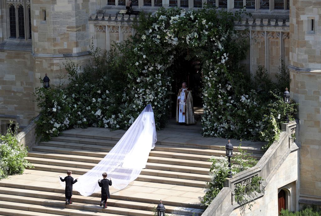 Meghan Markle walking up the steps at St George's Chapel in her wedding dress
