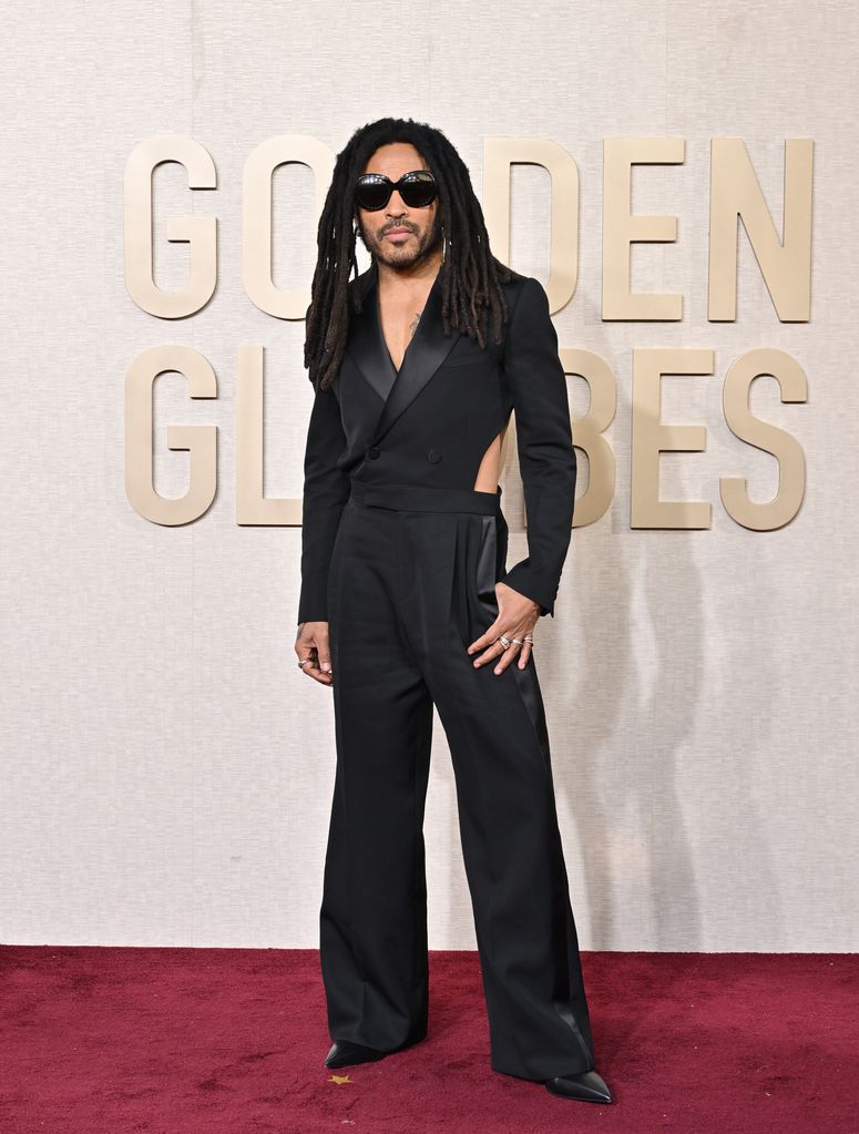 Lenny Kravitz in the same black suit on red carpet