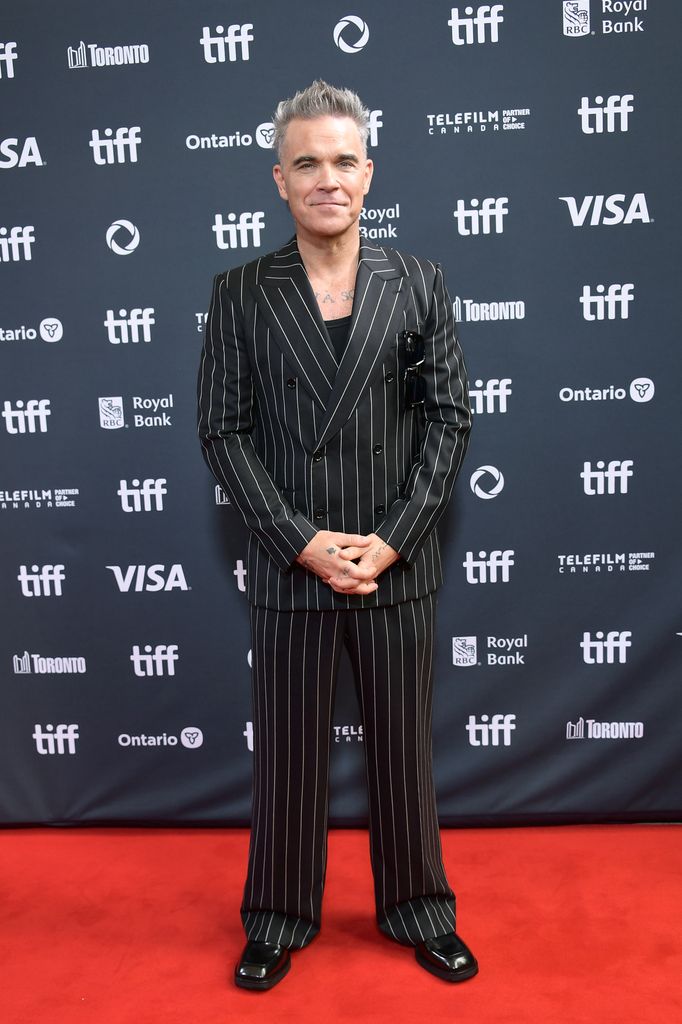 man in pinstripe suit on red carpet
