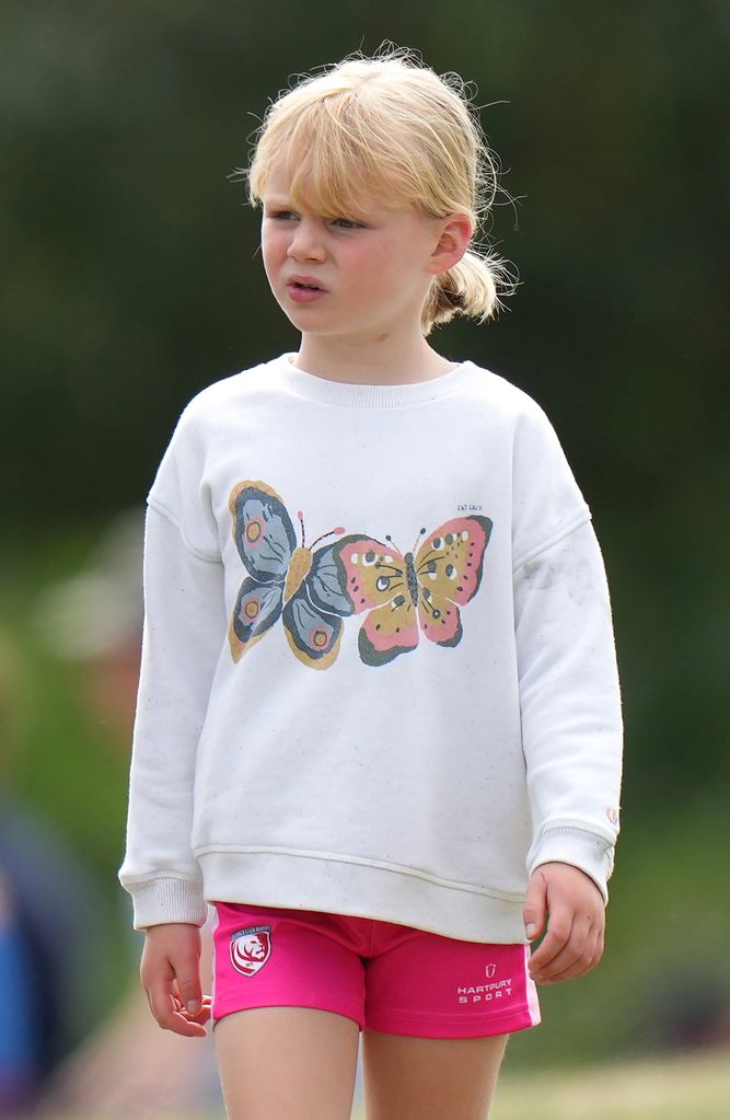 Lena Tindall wearing butterfly top and pink shorts