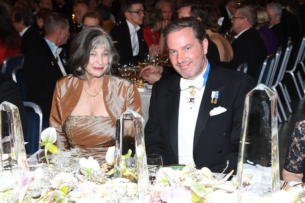 A woman sat with Christopher O'Neill