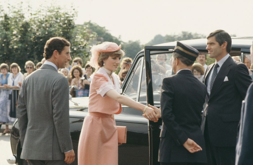 diana in peach suit shaking hand of man getting into car