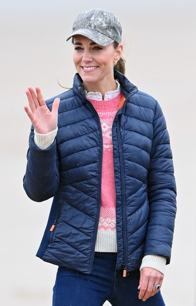 kate waving on beach 