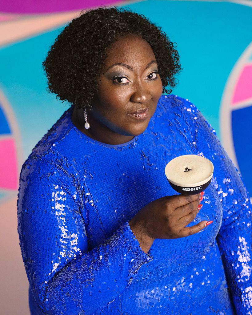 Lady Phyll holding an ABSOLUT cocktail