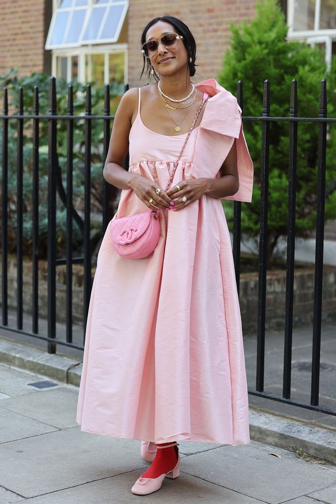 Guest wearing pink dress with pink Chanel handbag, sunglasses attends Bora Aksu at the Goodenough College during London Fashion Week September 2023 on September 15, 2023 in London, England. (Photo by Neil Mockford/Getty Images)