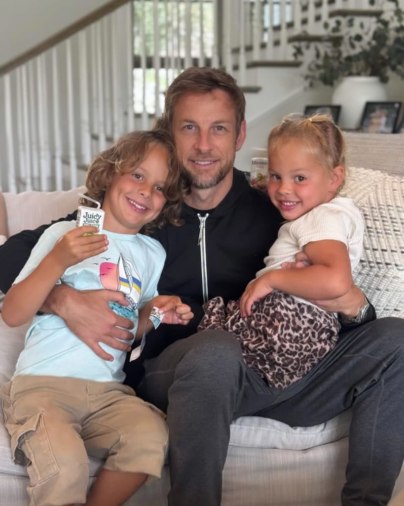 jenson button at home with son and daughter on his lap