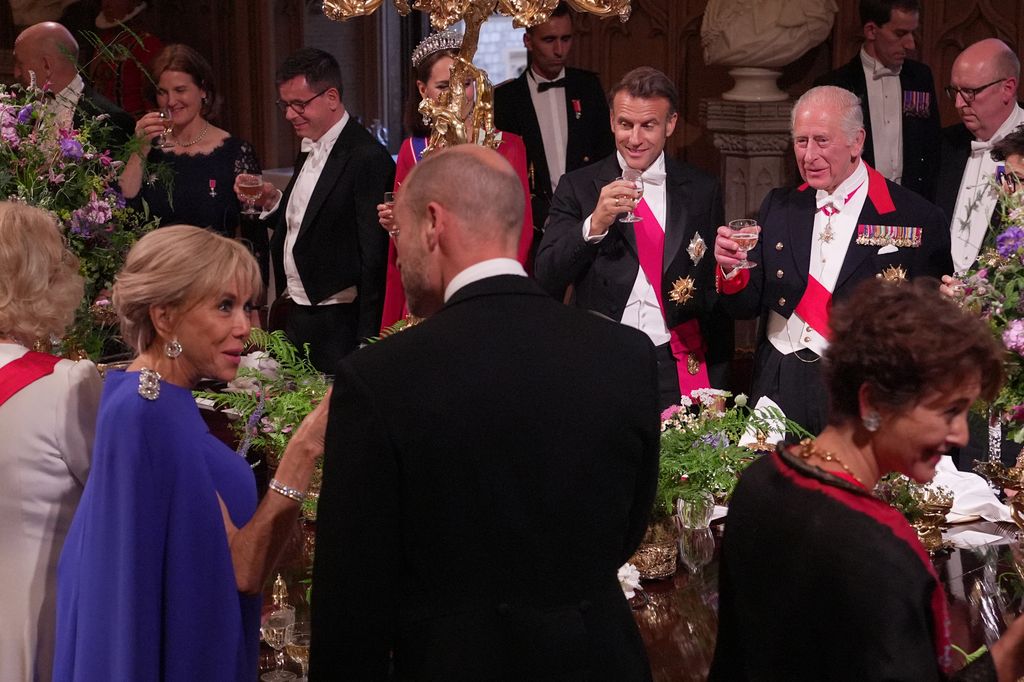 Prince William clinks glasses with Mrs Macron
