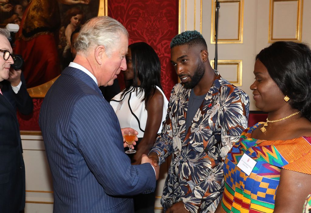 King Charles talking with musician Tinie Tempah at a reception to mark their upcoming tour to Gambia, Ghana and Nigeria at St James Palace on October 24, 2018