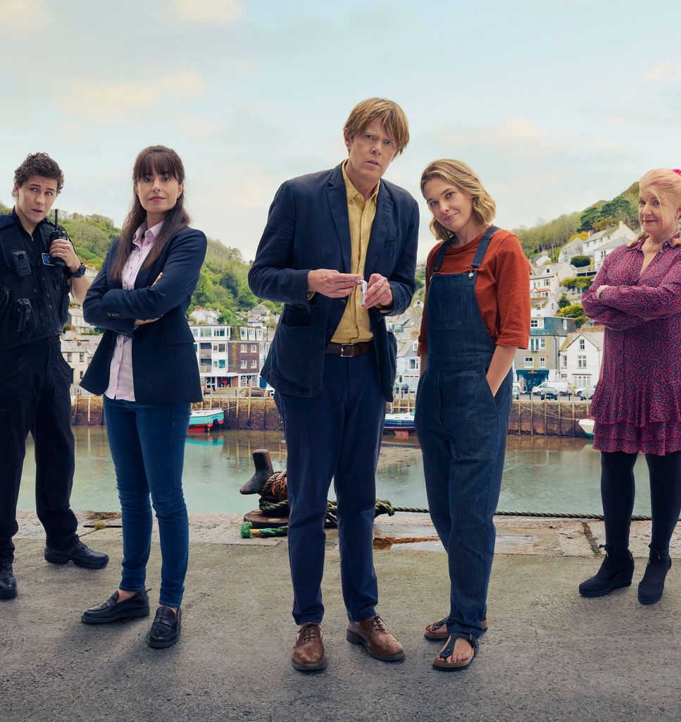 The cast of Beyond Paradise standing in the fictional 'Shipton Abbott' harbour
