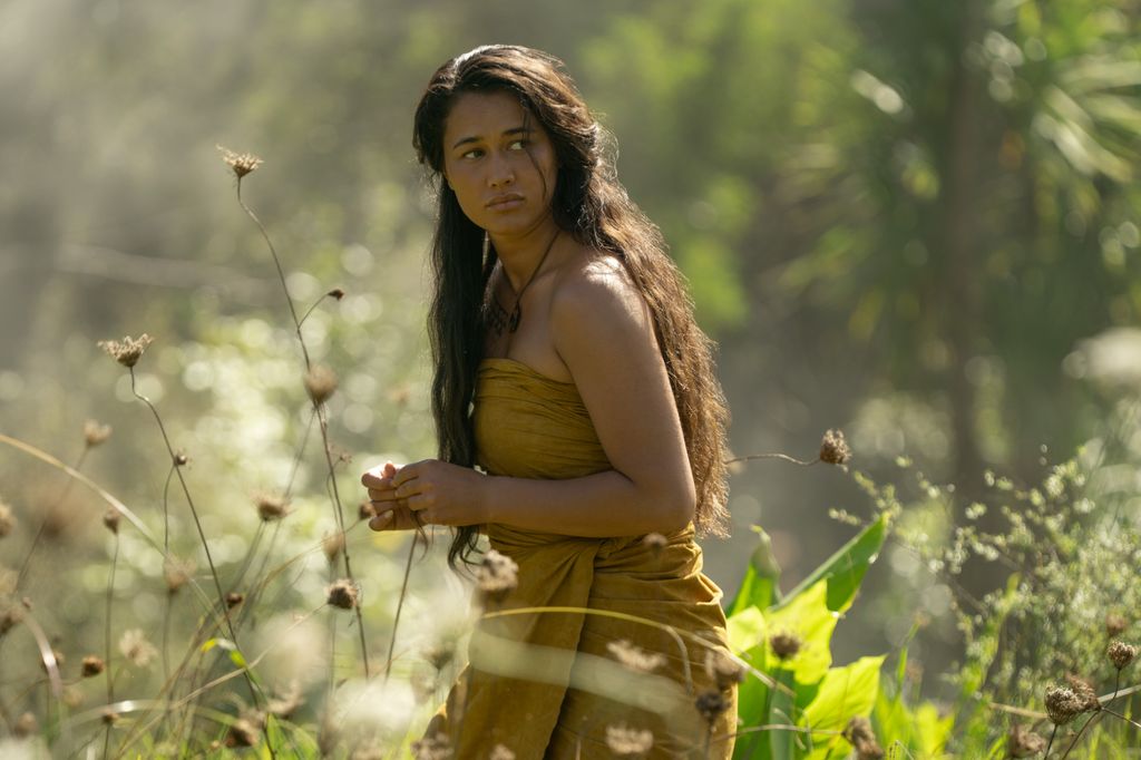 woman standing in field of flowers