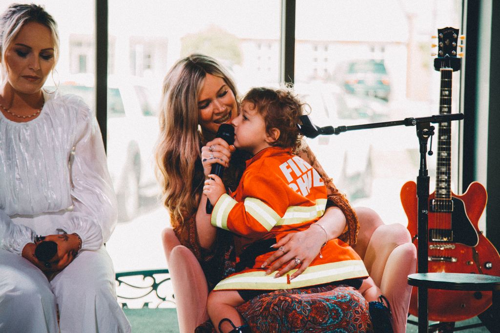 Joss Stone holding child on lap at Ease event