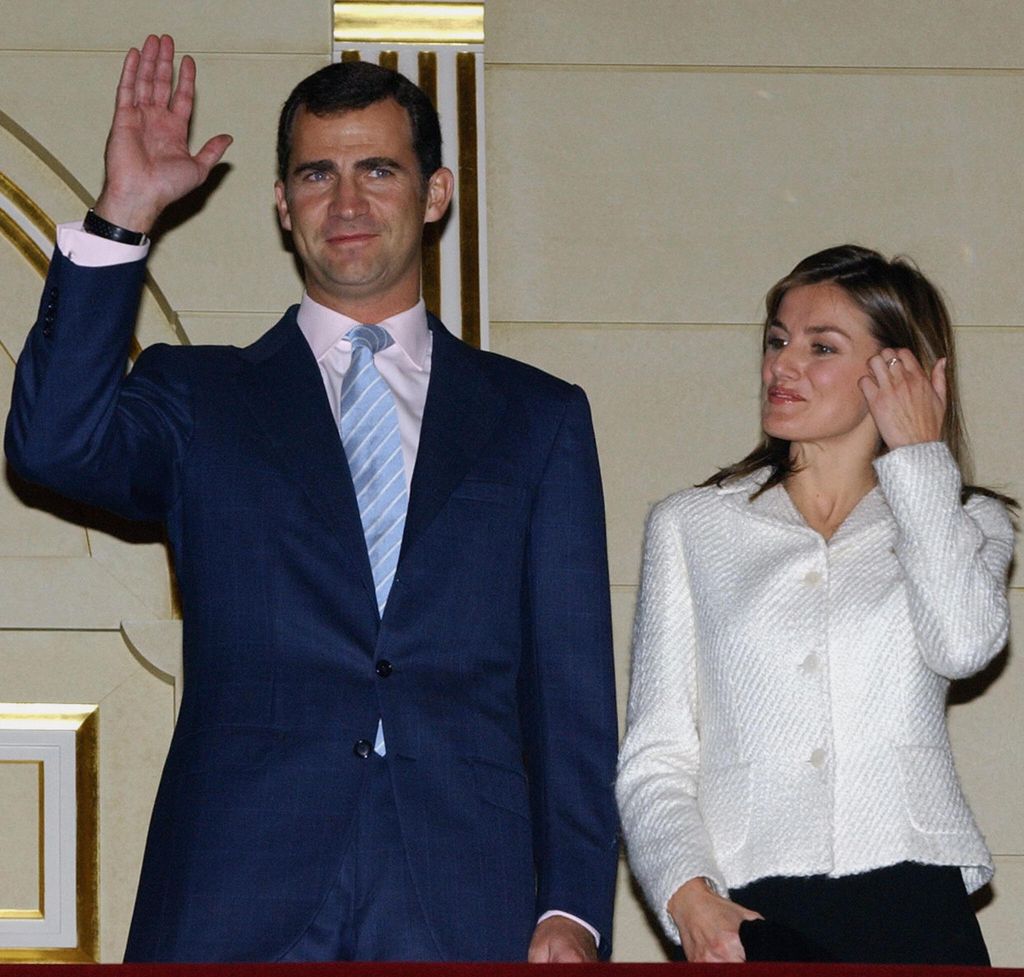 King Felipe waving next to Queen Letizia