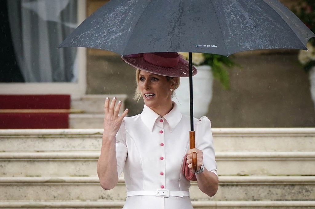 Zara Tindall in white button down shirt dress with pink hat at Buckingham Palace 