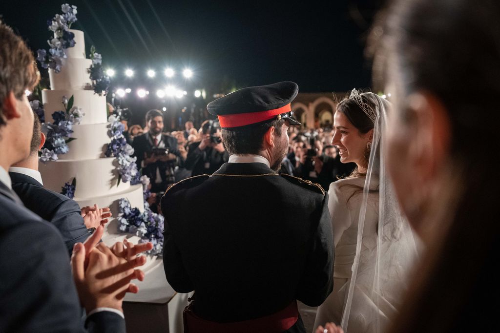 Prince Hussein and Princess Rajwa looking at each other