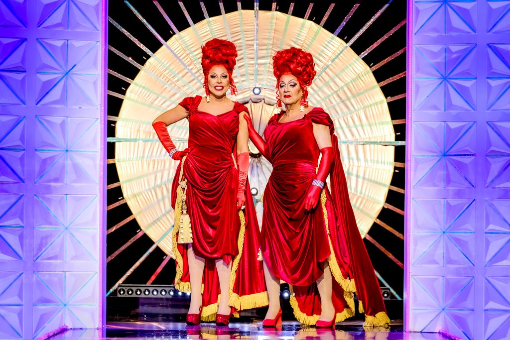 La Voix and her father, as Voix La, in red dresses and wigs