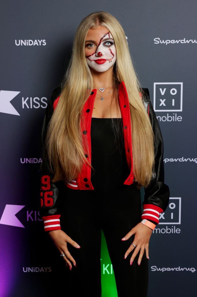 teenager posing in halloween outfit at party 